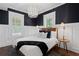 Stylish bedroom featuring dark wallpaper, hardwood floors, modern lighting and ample natural light at 1805 W Jetton Ave, Tampa, FL 33606