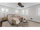 Cozy bedroom with neutral colors, ceiling fan, and natural light from shuttered windows at 1805 W Jetton Ave, Tampa, FL 33606