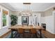 Well-lit dining room features a rustic table, modern lighting, and decorative art pieces at 1805 W Jetton Ave, Tampa, FL 33606