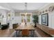 Dining room with a long wooden table, decorative plates, and wainscoting at 1805 W Jetton Ave, Tampa, FL 33606