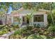 Charming bungalow with a front porch, verdant landscaping, and an American flag waving proudly at 1805 W Jetton Ave, Tampa, FL 33606