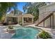 View of the backyard showing the in ground pool, outdoor bar area, and stairs to a second story deck at 1805 W Jetton Ave, Tampa, FL 33606