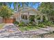 Charming two-story home with a well-manicured lawn, lush plantings, and a welcoming front porch at 1805 W Jetton Ave, Tampa, FL 33606