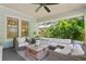 Comfortable front porch with wicker furniture, a rustic wood chest, and leafy green views at 1805 W Jetton Ave, Tampa, FL 33606