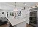 Spacious kitchen with a large island, seating, stainless steel refrigerator, and adjacent living area at 1805 W Jetton Ave, Tampa, FL 33606