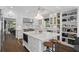 Bright kitchen featuring a large island with seating, marble countertops, and custom cabinetry at 1805 W Jetton Ave, Tampa, FL 33606
