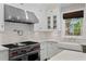 Well-appointed kitchen featuring a professional-grade range, farmhouse sink, and marble backsplash at 1805 W Jetton Ave, Tampa, FL 33606