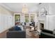 Bright living room featuring hardwood floors, wainscoting, fireplace, and large windows offering natural light at 1805 W Jetton Ave, Tampa, FL 33606