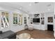 Bright living room featuring wood floors, built-in shelving, and French doors leading to the outdoors at 1805 W Jetton Ave, Tampa, FL 33606
