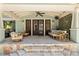 Covered outdoor living space with ceiling fan and comfortable seating arrangement at 1805 W Jetton Ave, Tampa, FL 33606