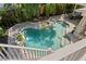 Beautiful geometric pool design with stone surround and lush tropical landscaping creating a private backyard oasis at 1805 W Jetton Ave, Tampa, FL 33606