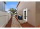 Sideyard features paver path, wood-look mulch, and a door to the exterior of the home at 1880 Fuller Dr, Clearwater, FL 33755