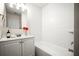 Well-lit bathroom featuring a vanity and a tiled shower-over-tub combination at 1880 Fuller Dr, Clearwater, FL 33755