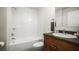 Bathroom featuring vanity and tub/shower combo with neutral tiling at 1880 Fuller Dr, Clearwater, FL 33755