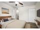 Bedroom with wood-look floors, closet, ceiling fan, and neutral paint at 1880 Fuller Dr, Clearwater, FL 33755