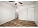 Bright bedroom with wood-look floors, a closet, and ceiling fan at 1880 Fuller Dr, Clearwater, FL 33755