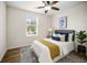 Charming bedroom with wood floors, a ceiling fan, and natural light from the window at 1880 Fuller Dr, Clearwater, FL 33755