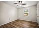 Bedroom features wood floors, a ceiling fan, natural light and spacious layout at 1880 Fuller Dr, Clearwater, FL 33755