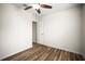 Empty bedroom featuring wood-look floors, ceiling fan, and neutral paint at 1880 Fuller Dr, Clearwater, FL 33755