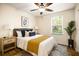 Cozy bedroom with wood floors, a ceiling fan, and natural light from the window at 1880 Fuller Dr, Clearwater, FL 33755