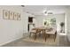 Light-filled dining room featuring a wooden table, six chairs, and modern decor at 1880 Fuller Dr, Clearwater, FL 33755