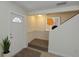 Inviting foyer with bright natural light and a modern staircase at 1880 Fuller Dr, Clearwater, FL 33755
