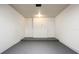 View of the clean garage, painted white, with painted gray floor and white door at 1880 Fuller Dr, Clearwater, FL 33755
