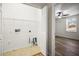 Clean laundry room featuring tile floor, bi-fold door, and wire shelving at 1880 Fuller Dr, Clearwater, FL 33755