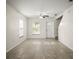 Bright living room features tile floors, a ceiling fan, and a front door leading to the exterior at 1880 Fuller Dr, Clearwater, FL 33755