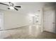 Bright living room with tile floors, neutral walls, ceiling fans, and natural light from window at 1880 Fuller Dr, Clearwater, FL 33755