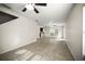 Spacious living room featuring tile floors, neutral walls, and ceiling fan adjacent to the kitchen at 1880 Fuller Dr, Clearwater, FL 33755