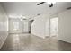Open-concept living room features tile floors, ceiling fan, and staircase to the upper level at 1880 Fuller Dr, Clearwater, FL 33755