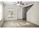 Bright living room featuring tile floors, a front door, and staircase at 1880 Fuller Dr, Clearwater, FL 33755