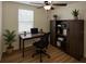 Cozy home office with natural light, desk, bookcase, and ceiling fan at 1880 Fuller Dr, Clearwater, FL 33755