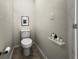 Small half bathroom with neutral color scheme, tiled floor and modern fixtures at 1880 Fuller Dr, Clearwater, FL 33755