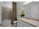 Bathroom featuring a tub with shower, toilet, vanity with white cabinets and a large mirror at 18913 Indian Rock Pl, Lakewood Ranch, FL 34211