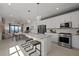Modern kitchen featuring white cabinets, stainless steel appliances, and island seating at 18913 Indian Rock Pl, Lakewood Ranch, FL 34211