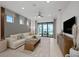 Bright and open living room with modern furnishings and a view of the lake at 18913 Indian Rock Pl, Lakewood Ranch, FL 34211