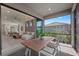 Outdoor patio features a dining table with chairs, sliding glass doors leading into the living room at 18913 Indian Rock Pl, Lakewood Ranch, FL 34211