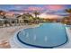 Stunning resort-style pool featuring palm trees, sun loungers, and fountain features, creating a tranquil oasis at 18913 Indian Rock Pl, Lakewood Ranch, FL 34211