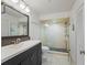 Modern bathroom featuring a sleek vanity, glass-enclosed shower with updated fixtures and tile flooring at 20019 Gulf Blvd # 1, Indian Shores, FL 33785