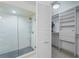 Modern bathroom featuring glass enclosed shower, closet and tiled floors at 20019 Gulf Blvd # 1, Indian Shores, FL 33785