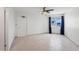 Spacious, sunlit bedroom features neutral tile, ceiling fan, and a large window with water views at 20019 Gulf Blvd # 1, Indian Shores, FL 33785
