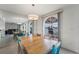 Dining area with a wooden table set, modern chandelier, and views of the water at 20019 Gulf Blvd # 1, Indian Shores, FL 33785