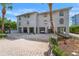 Multi-level coastal home with ground-level parking, showcasing classic beach architecture and curb appeal at 20019 Gulf Blvd # 1, Indian Shores, FL 33785