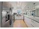 Well-lit kitchen with modern appliances, extended countertops, and a beautiful mirrored backsplash at 20019 Gulf Blvd # 1, Indian Shores, FL 33785