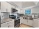 Modern kitchen equipped with stainless steel appliances, sleek cabinetry, and a stylish backsplash at 20019 Gulf Blvd # 1, Indian Shores, FL 33785