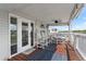 Charming porch with dining set, wood floors, stylish rugs, and easy access from interior with scenic views at 20019 Gulf Blvd # 1, Indian Shores, FL 33785
