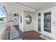 Inviting porch with decor, wood floors, stylish rugs, and easy access from interior at 20019 Gulf Blvd # 1, Indian Shores, FL 33785