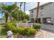 Charming community signage amidst lush landscaping, welcoming residents and guests to this waterfront property at 20019 Gulf Blvd # 1, Indian Shores, FL 33785